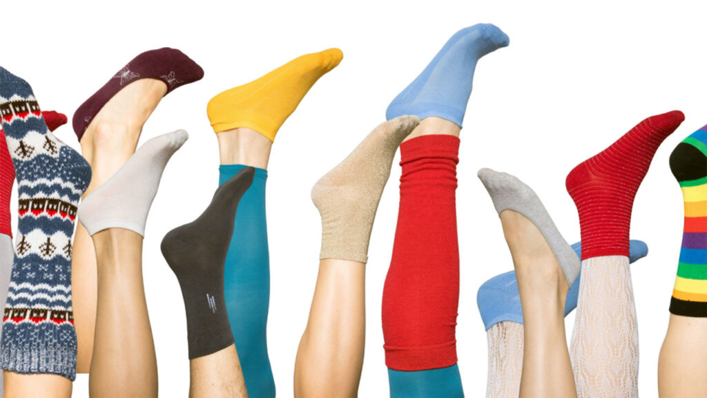 a bunch of people wearing socks that are upside down. it is helping portray the role of socks in foot health.